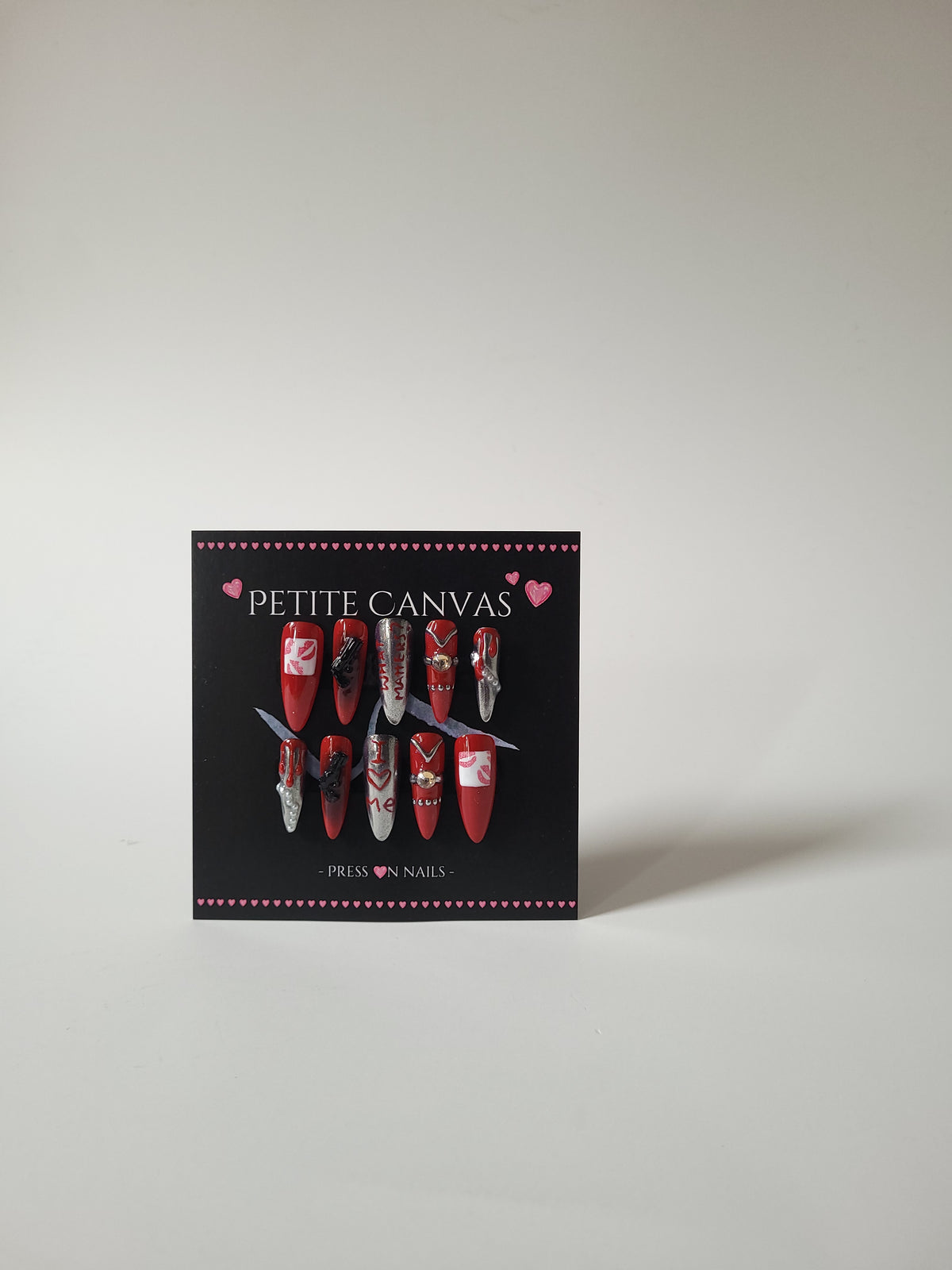 Bad Widow full press-on nail set on display card — red and silver black-widow inspired nail art, long stiletto