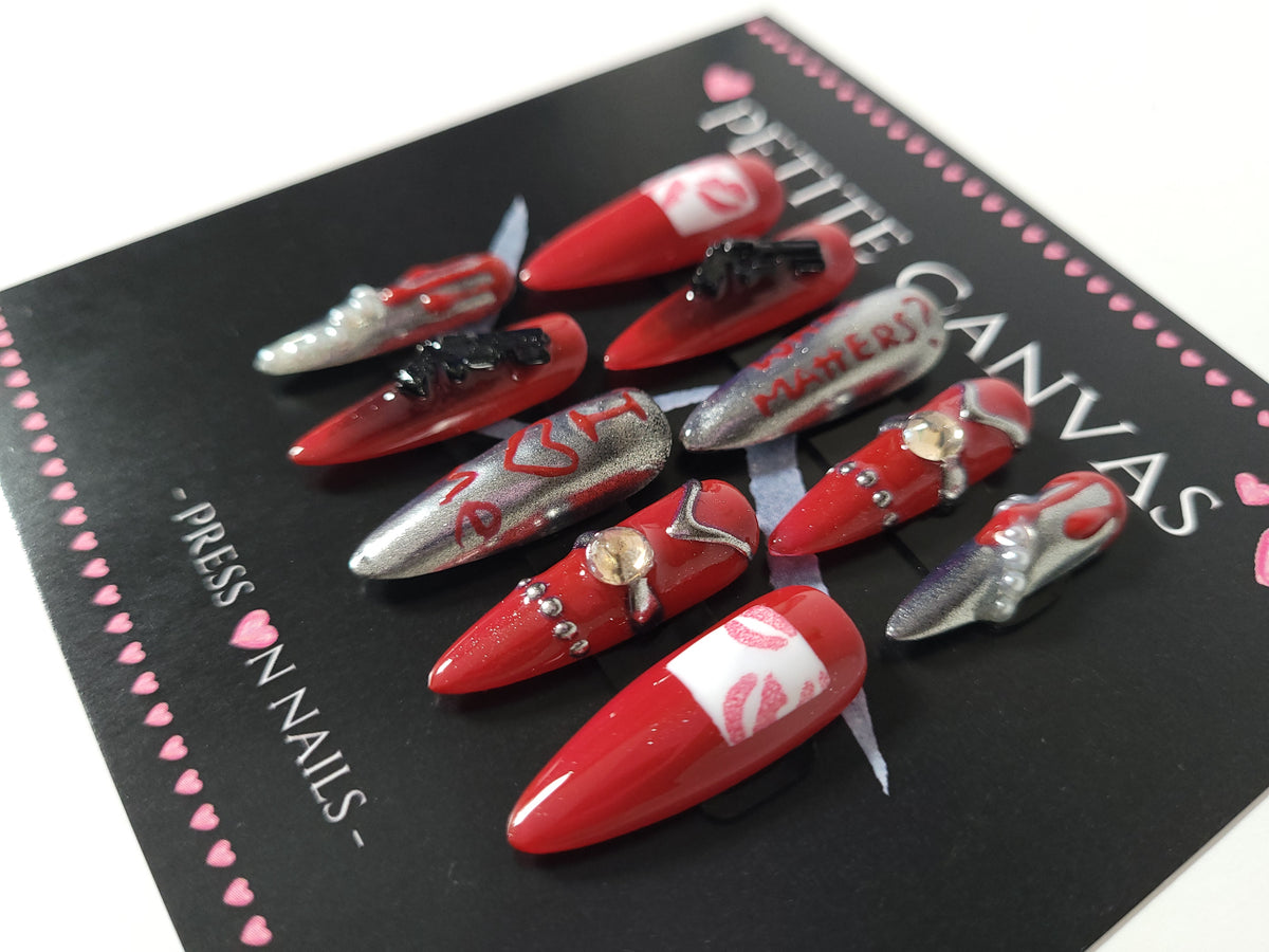 Close-up of Bad Widow long stiletto press-on nails — deep red and silver with mirrors, rhinestones, pearls and lip prints
