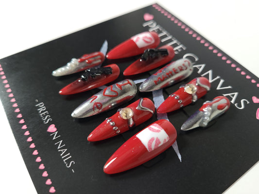Close-up of Bad Widow long stiletto press-on nails — deep red and silver with mirrors, rhinestones, pearls and lip prints