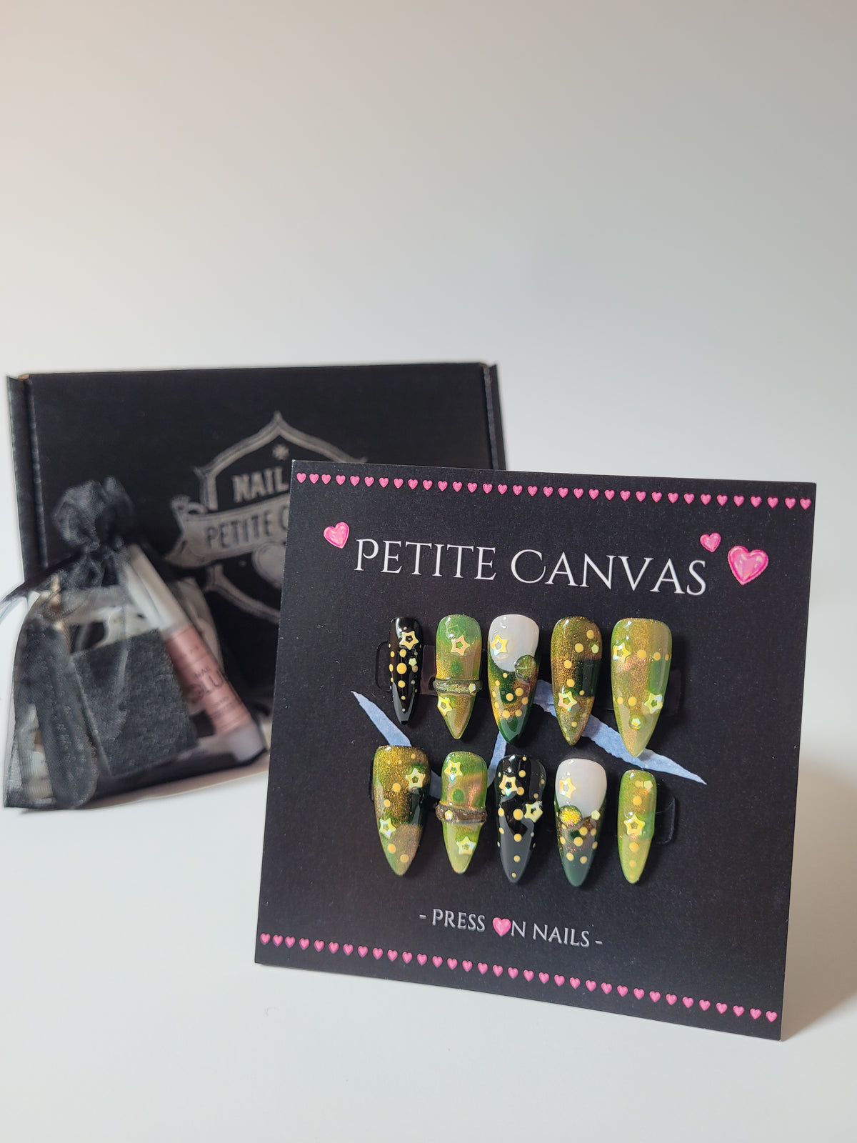 A Fairy Night press-on nail set — green cat-eye polish with stars and fairy dust on medium stilettos, with gift box and kit