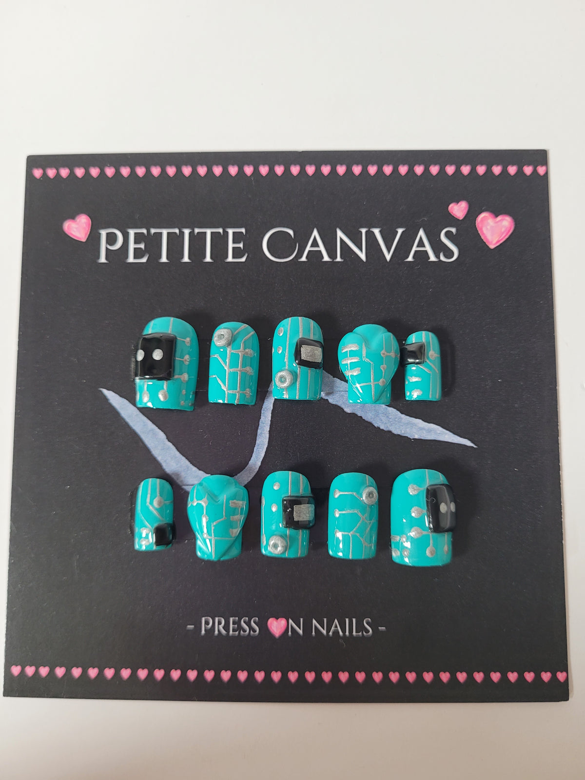 Bot 1026B press-on nails detail — circuit-board lines and metallic accents on turquoise