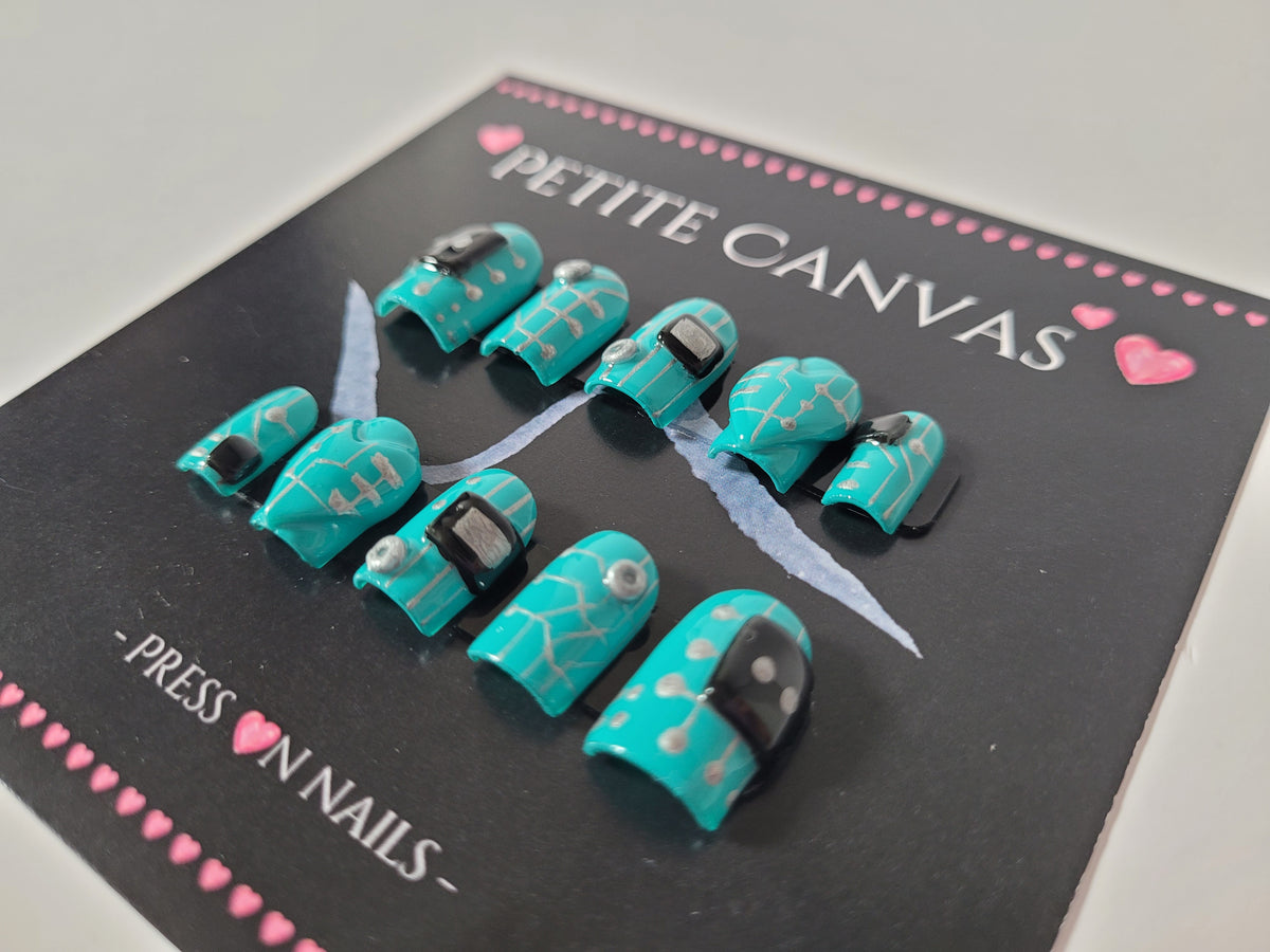 Close-up of Bot 1026B small square press-on nails — turquoise circuit-board pattern with black and silver tech details