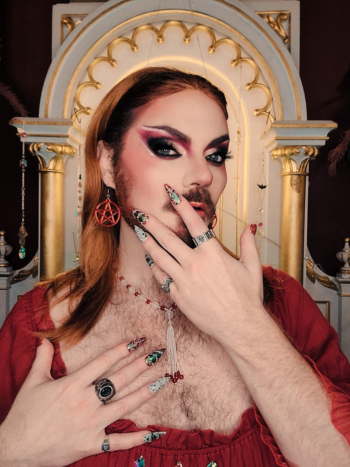 Tristan Ginger wearing Confessions Baroque long stiletto press-on nails — crimson, cream and chrome with pearls