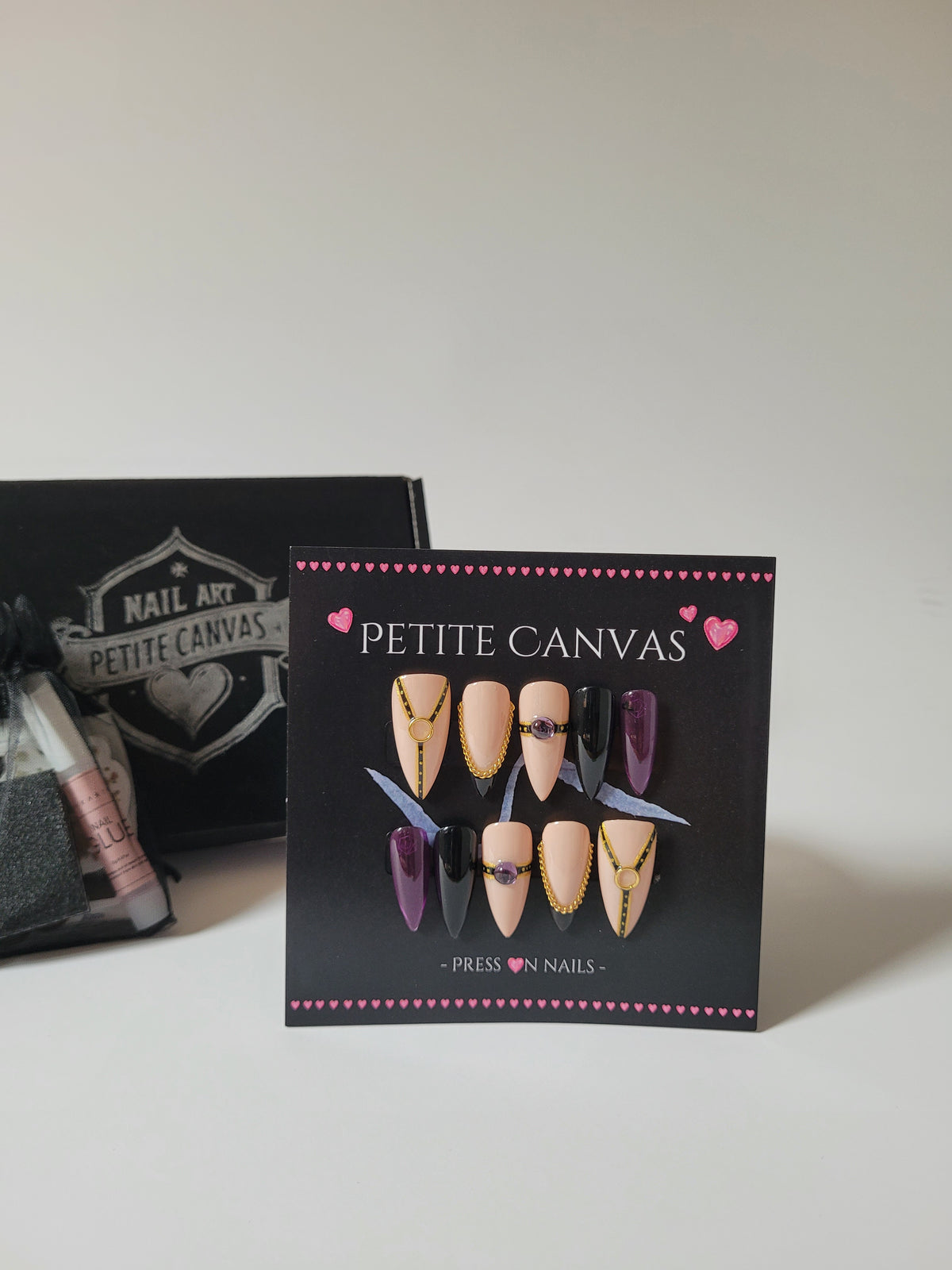 Whip-Me press-on nails in Purple — medium stiletto, nude, purple and black with gold chain details, with gift box